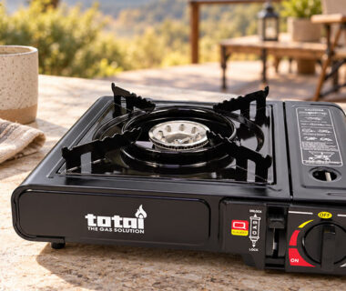 Totai portable single-burner gas stove on an outdoor table, ideal for camping, outdoor cooking and entertaining.